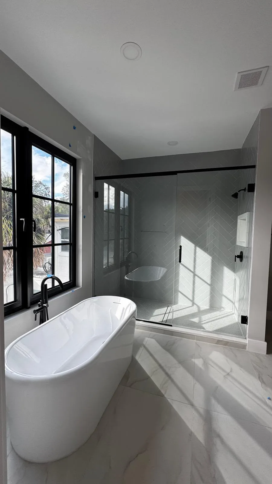 Freestanding tub with frameless glass shower